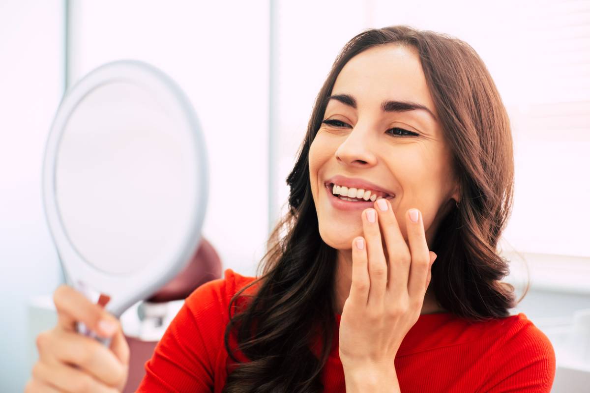 concept image of woman checking for dental implants being stained