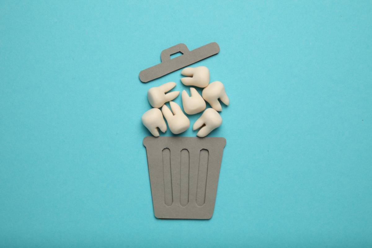 Teeth going into a trash can after tooth loss